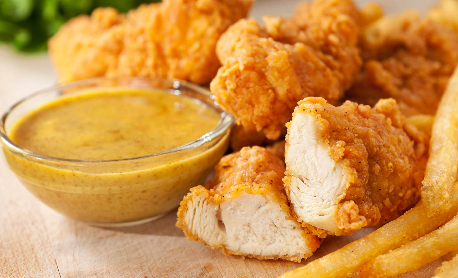 chicken tenders served with a side of honey mustard dipping sauce