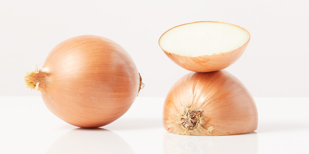 Onion, grocery store produce, on a blank background.
