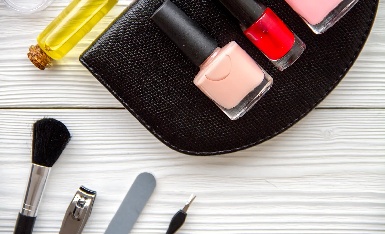 A photo of nail polishes and a manicure tool kit.