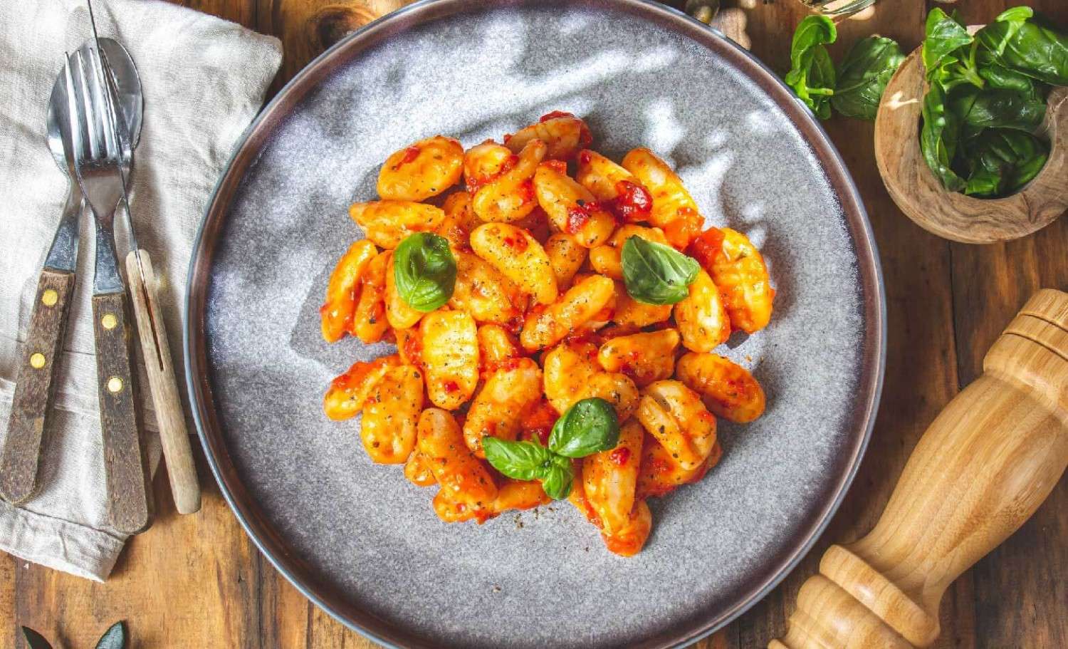 a stock photo of gnocchi and tomato cream sauce