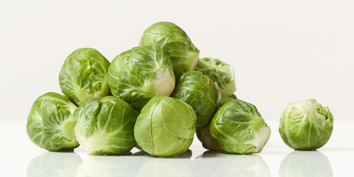 Brussels sprouts, grocery store produce, on a blank background.
