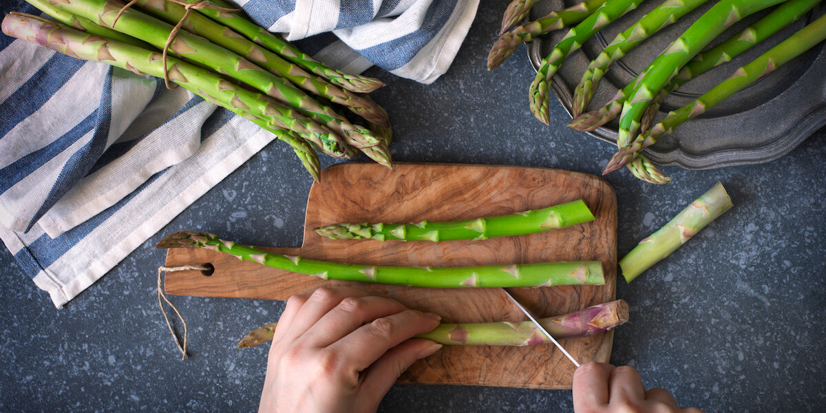 Fresh raw asparagus on stone background.