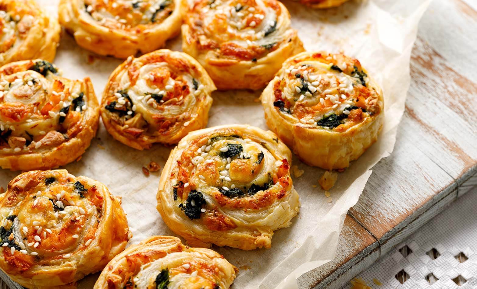 spinach and cheese pinwheels on parchment paper