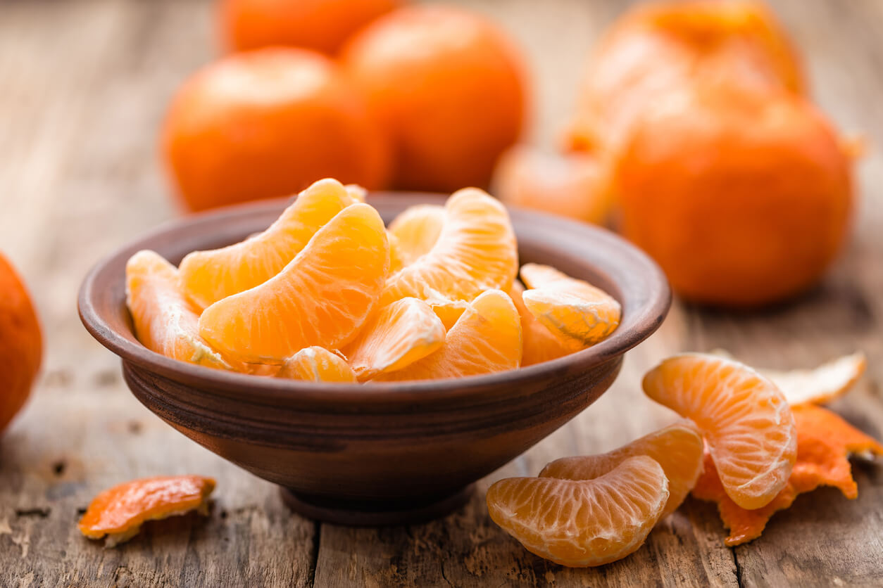 Mandarin oranges in a bowl on a table.