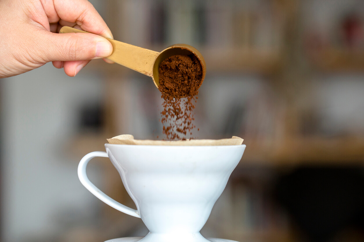 pouring coffee powder to a filter cup
