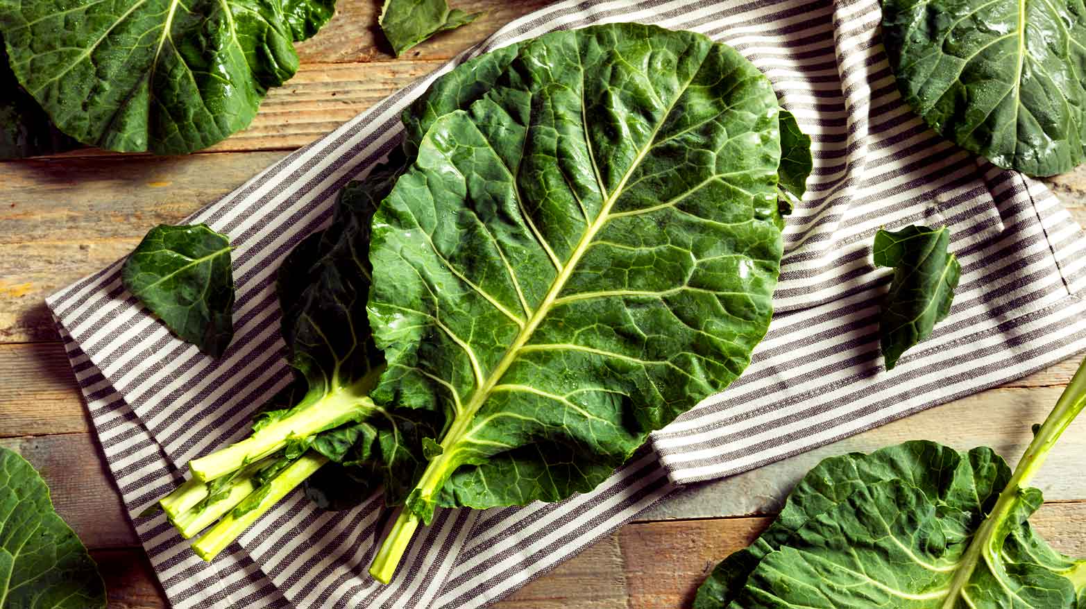 A pile of collard greens laid out on a dish towel