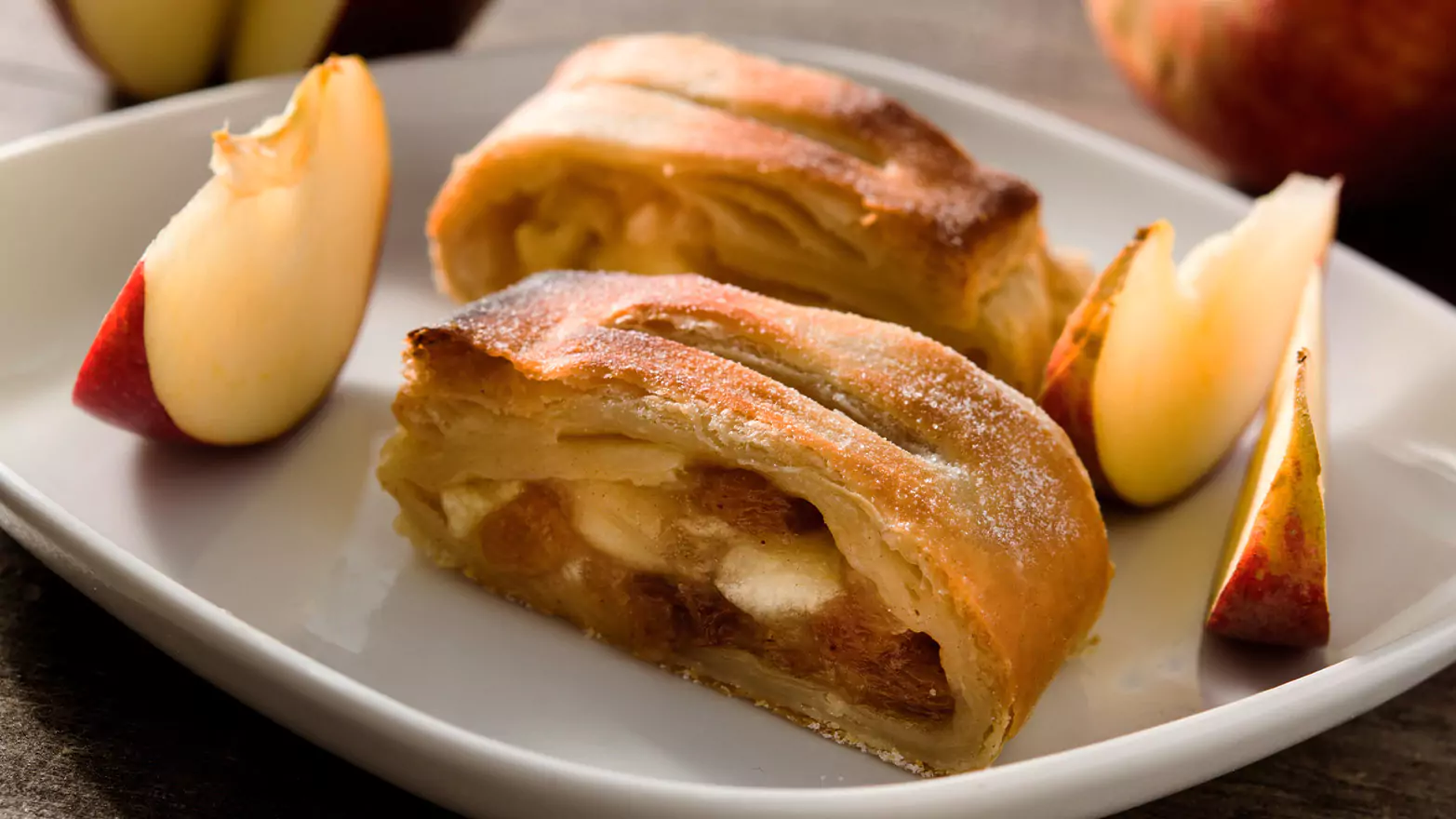 Cross section view of apple danish pastries served with apple slices