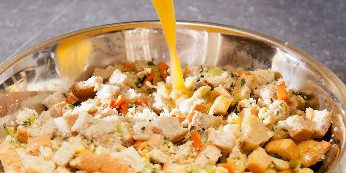Adding broth to dry stuffing mix.