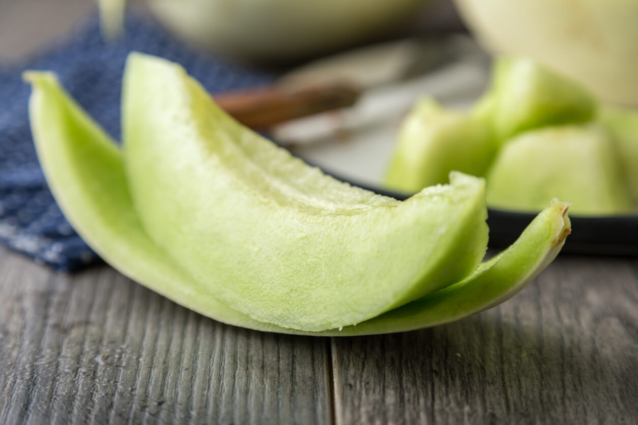 sliced ripe melon on rustic wooden background