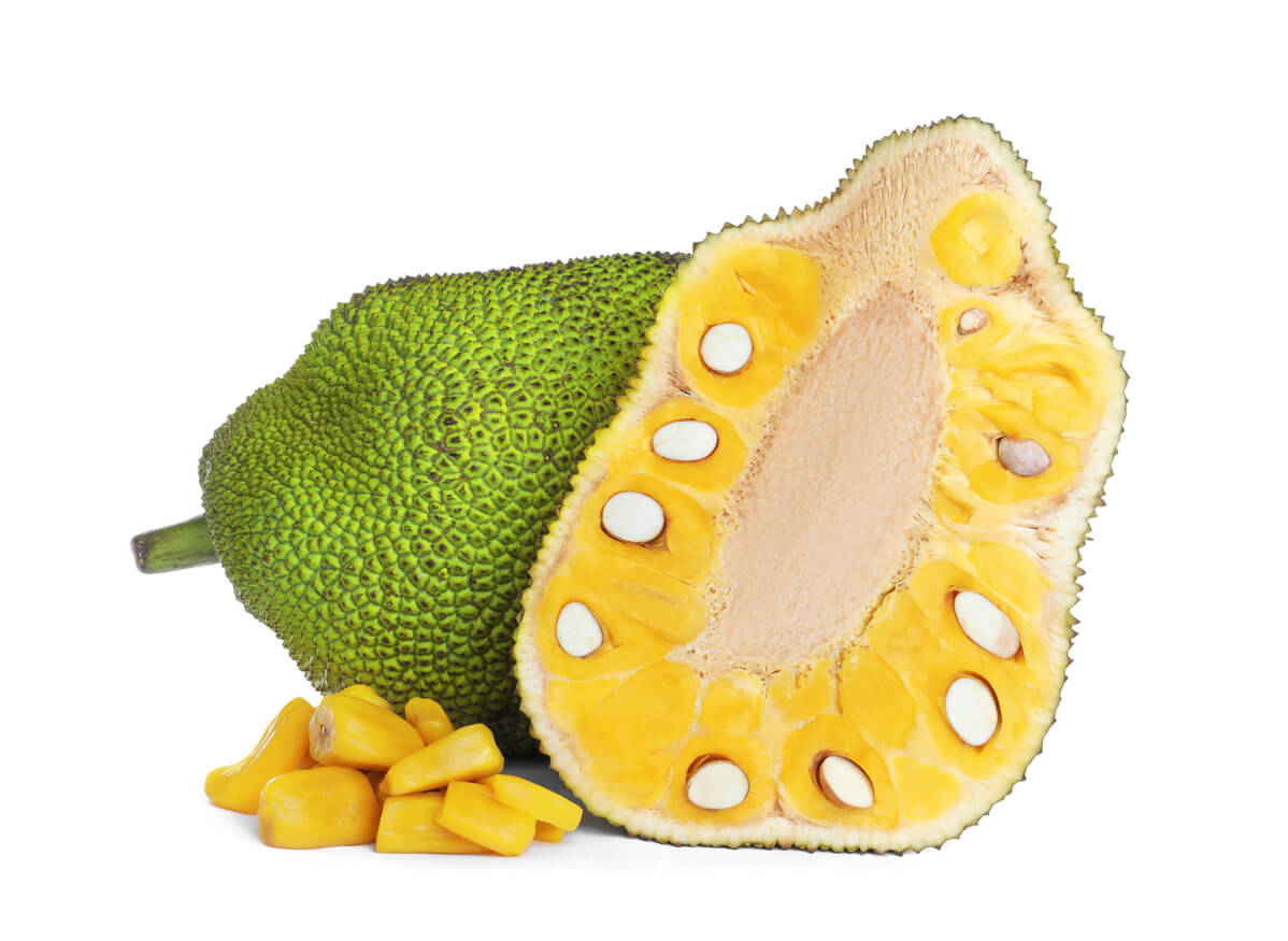 Cut and whole delicious fresh exotic jackfruits on white background