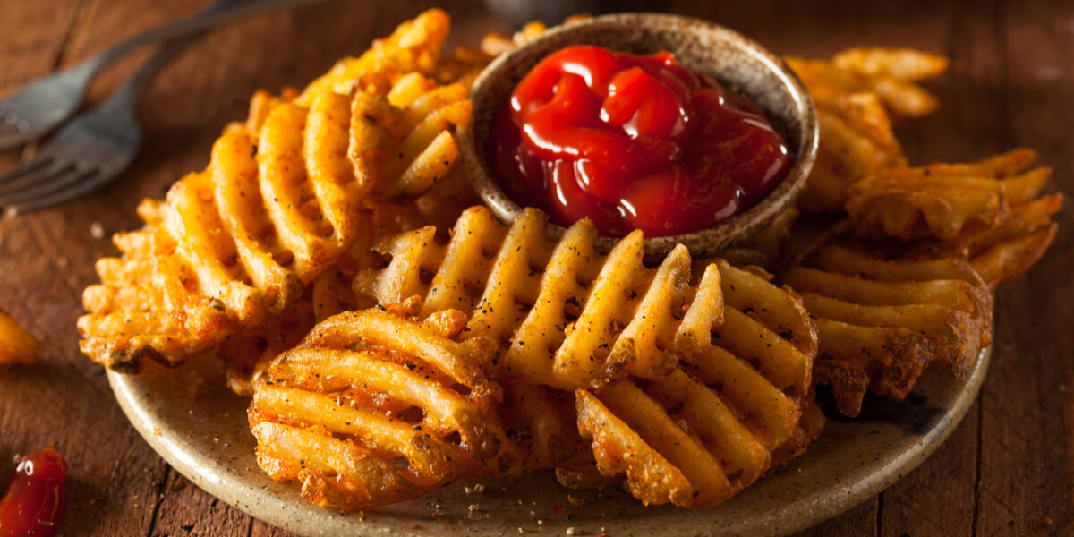 Cut potatoes, french fries, on a table.