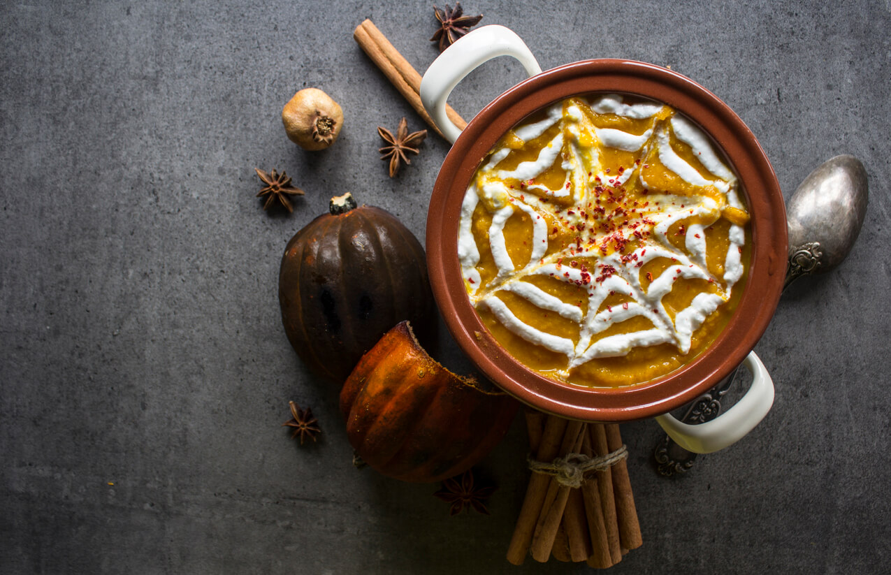 Spicy squash soup in ceramic pot.