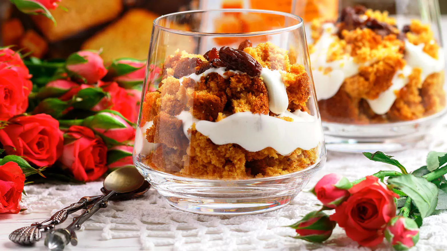 Pumpkin trifle in a cup surrounded by roses