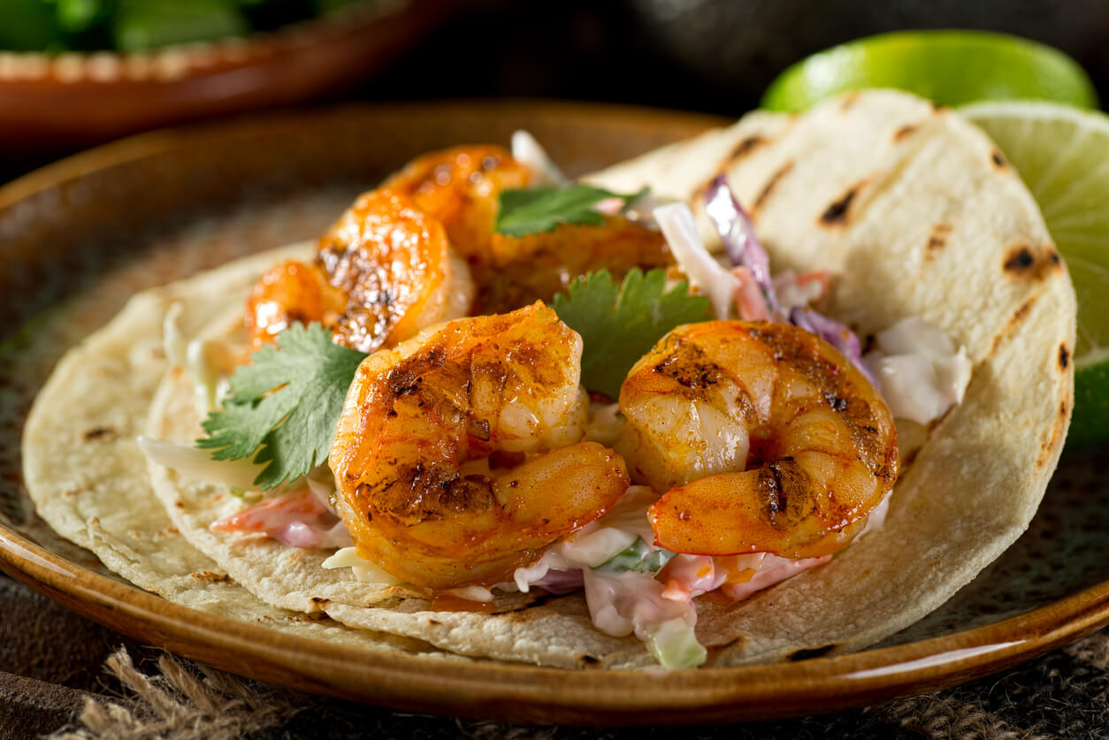 Delicious spicy shrimp taco with creamy cilantro slaw and lime.