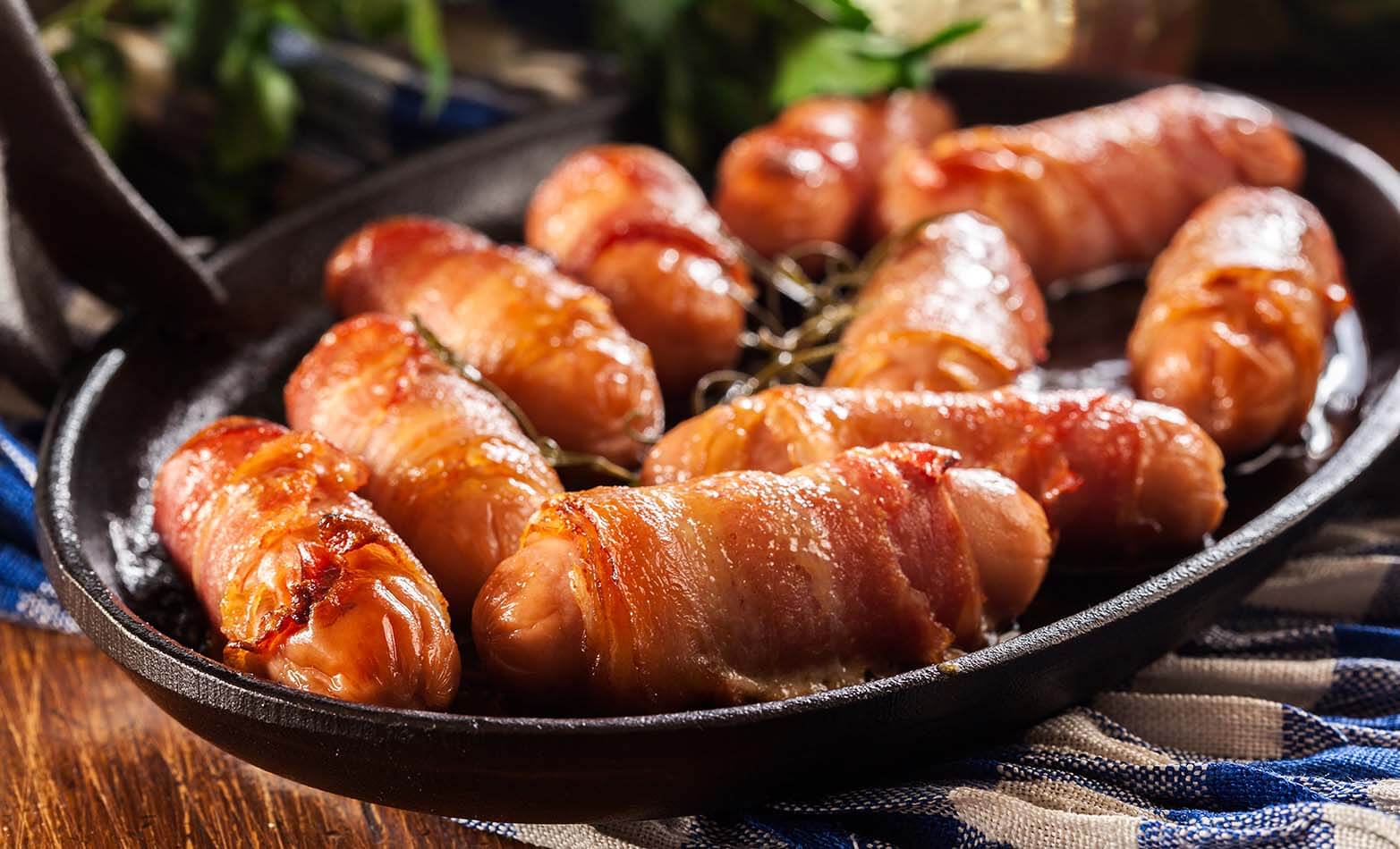 a serving dish of bacon-wrapped mini sausages