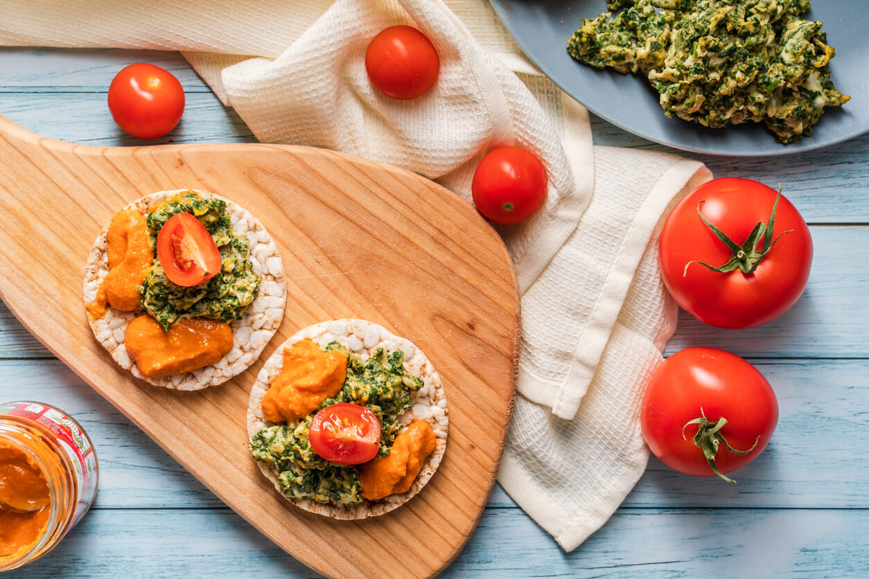 spinach and artichoke dip rice cake on a plate.