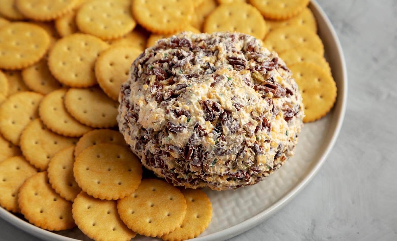 loaded cheese ball party spread with crackers