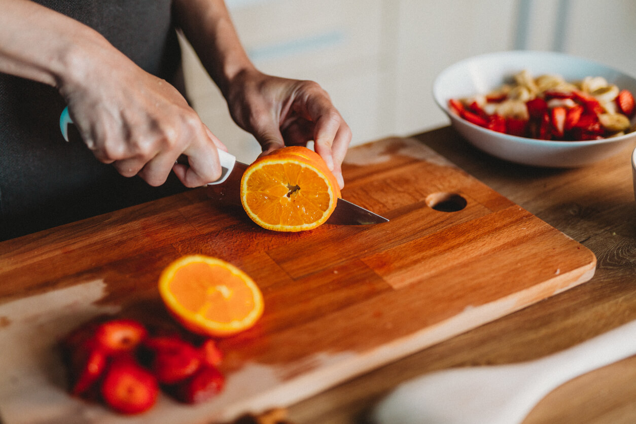 Woman cutting fruit in the kitchen