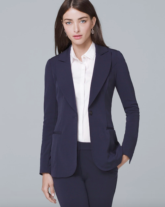 Brunette woman in a long, hip-length navy blue blazer with one button