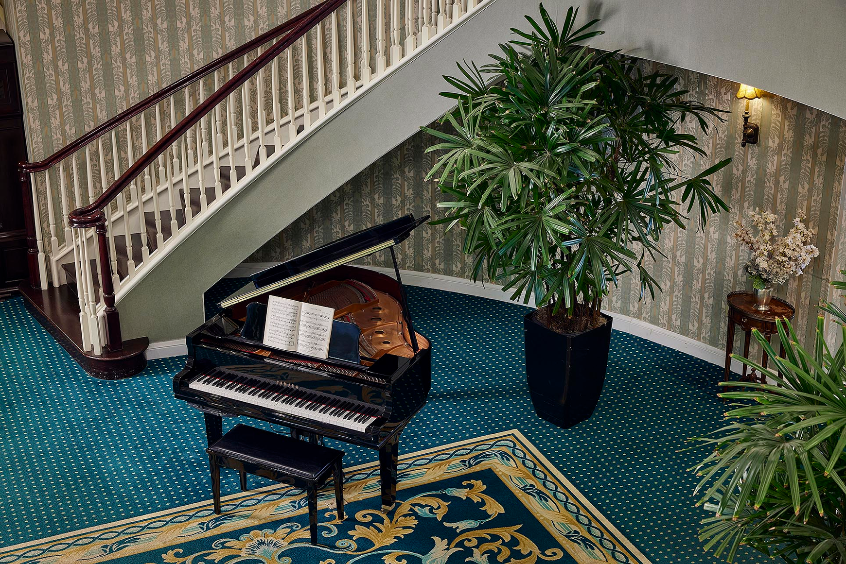 A stately baby grand in the stately lobby