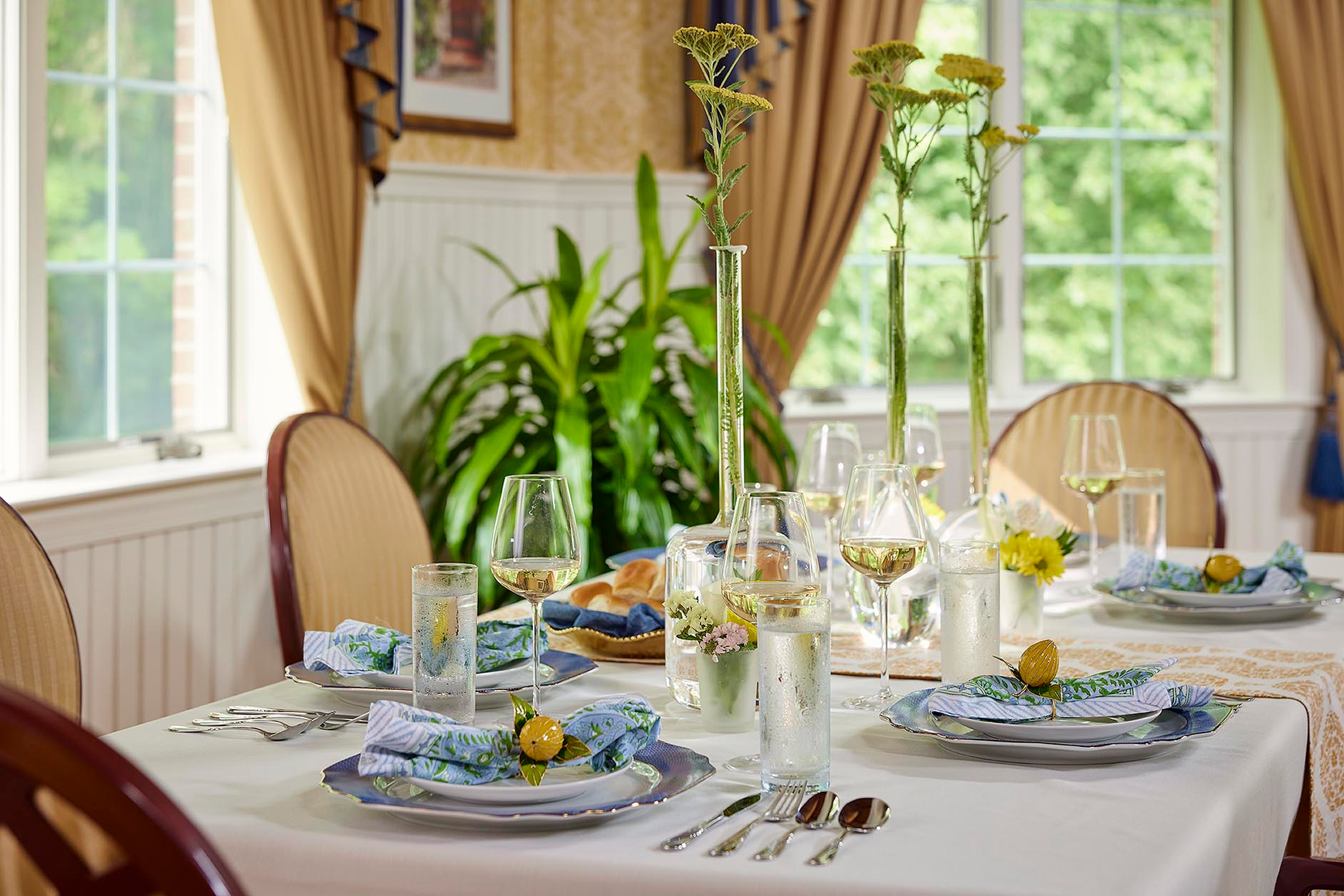 A table set with colorful linens and fresh flowers ready for lunch