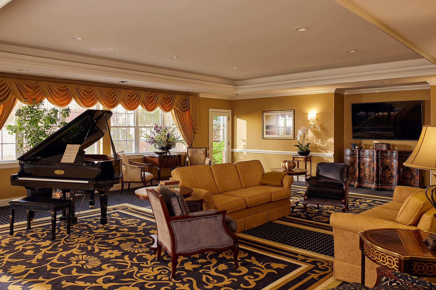 A baby grand piano with armchairs and sofas in the living room