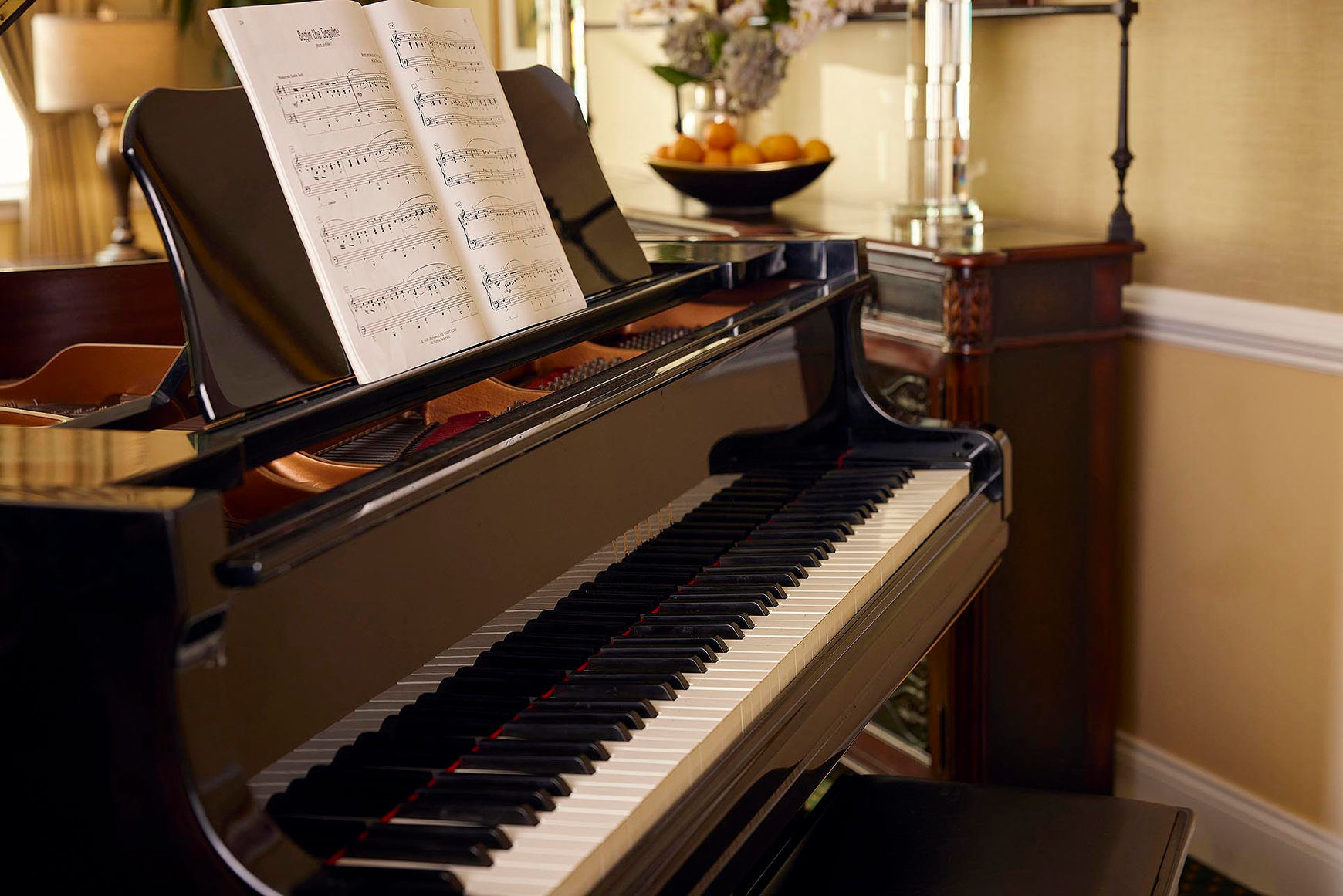 A piano and sheet music ready for an afternoon sing along