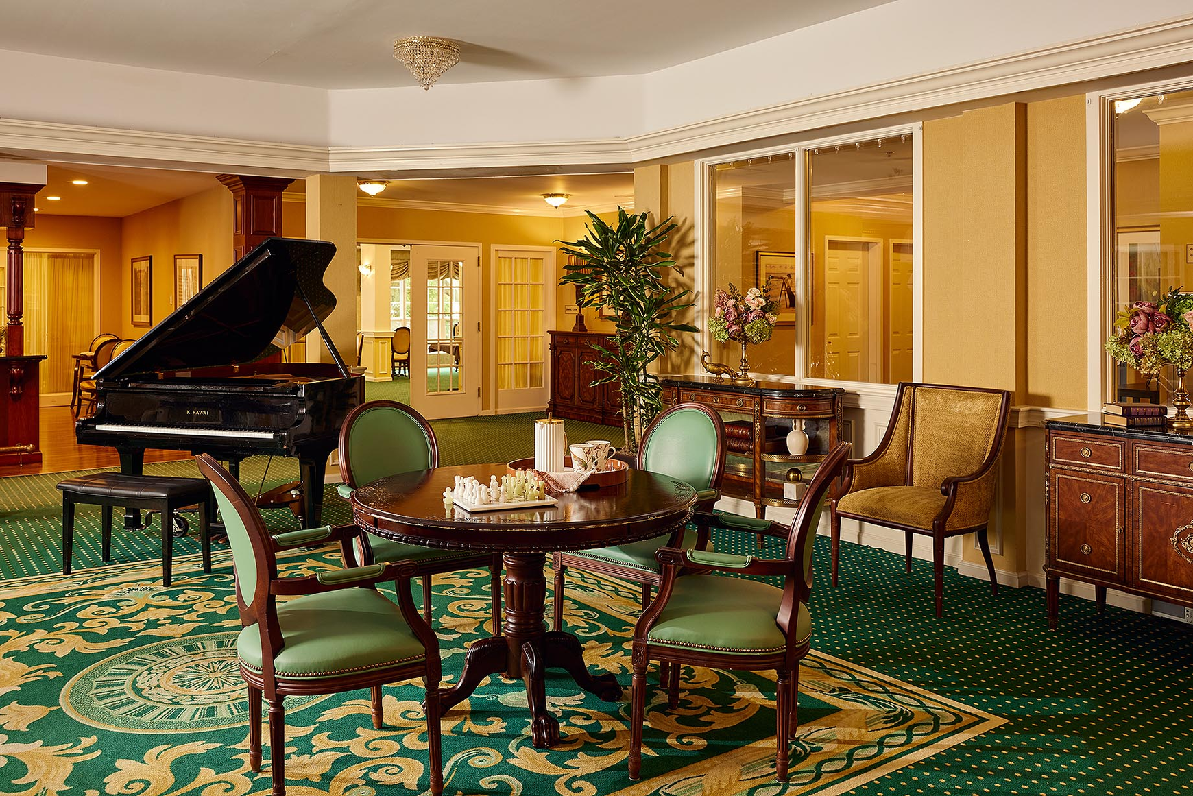 A game of chess and a baby grand piano in the lobby