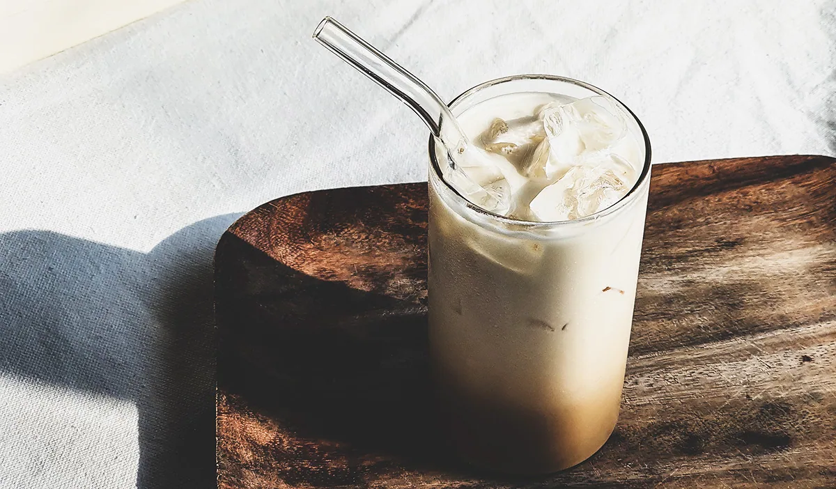 Ice coffee with a glass straw