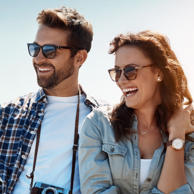 Two people smiling in their sunglasses