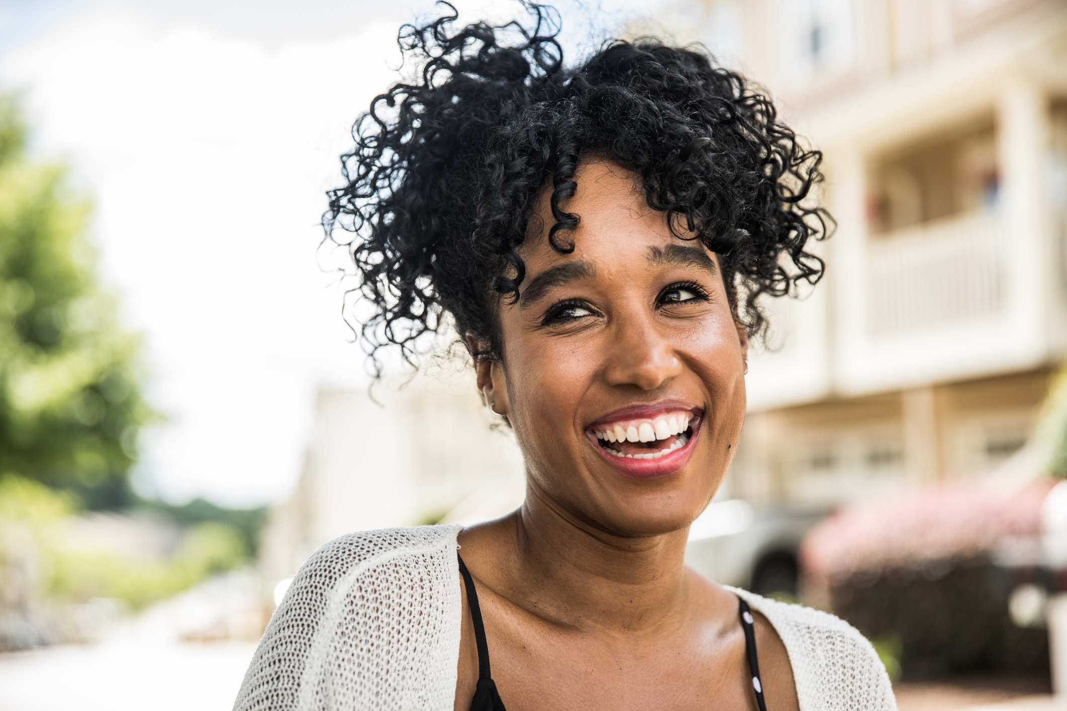 Woman with curly hair smiling