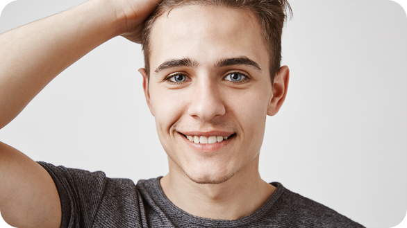 Young man with hand on his head and smiling
