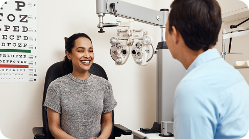 Doctor talks to a patient in the chair during eye exam