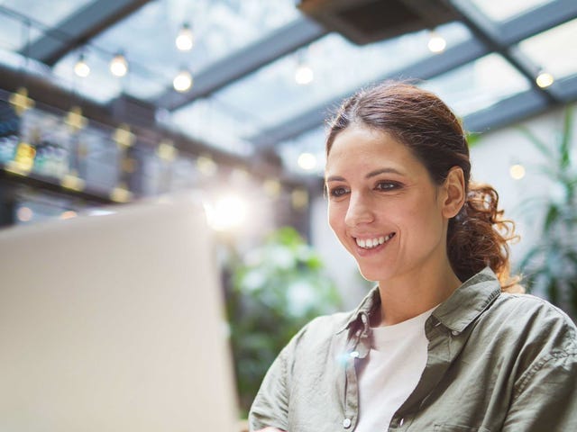 Woman sitting in front of a laptop and attending and learning a language online with Berlitz El Salvador