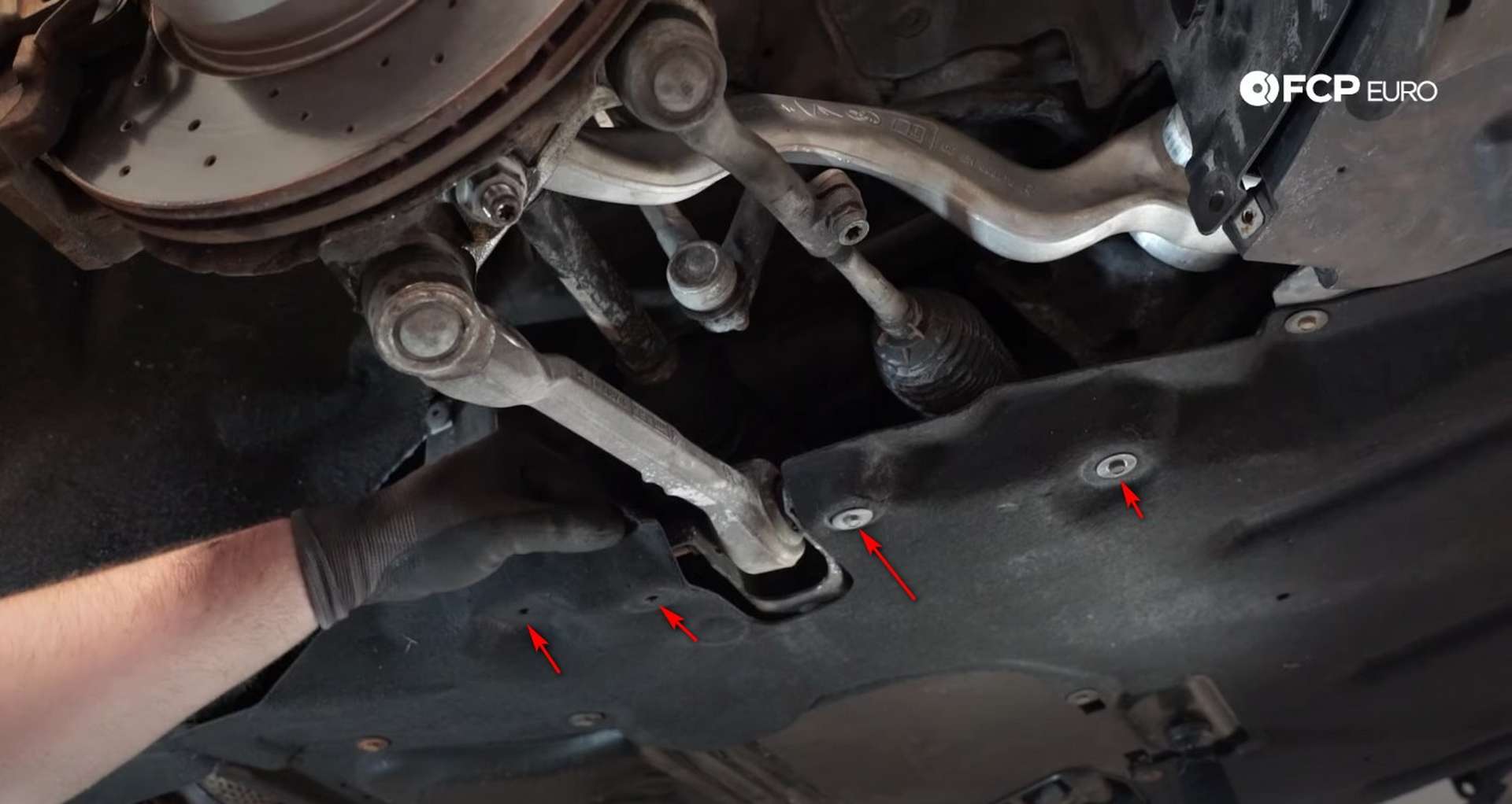 DIY BMW F30 Front Control Arm Replacement removing the fasteners from the splash shield