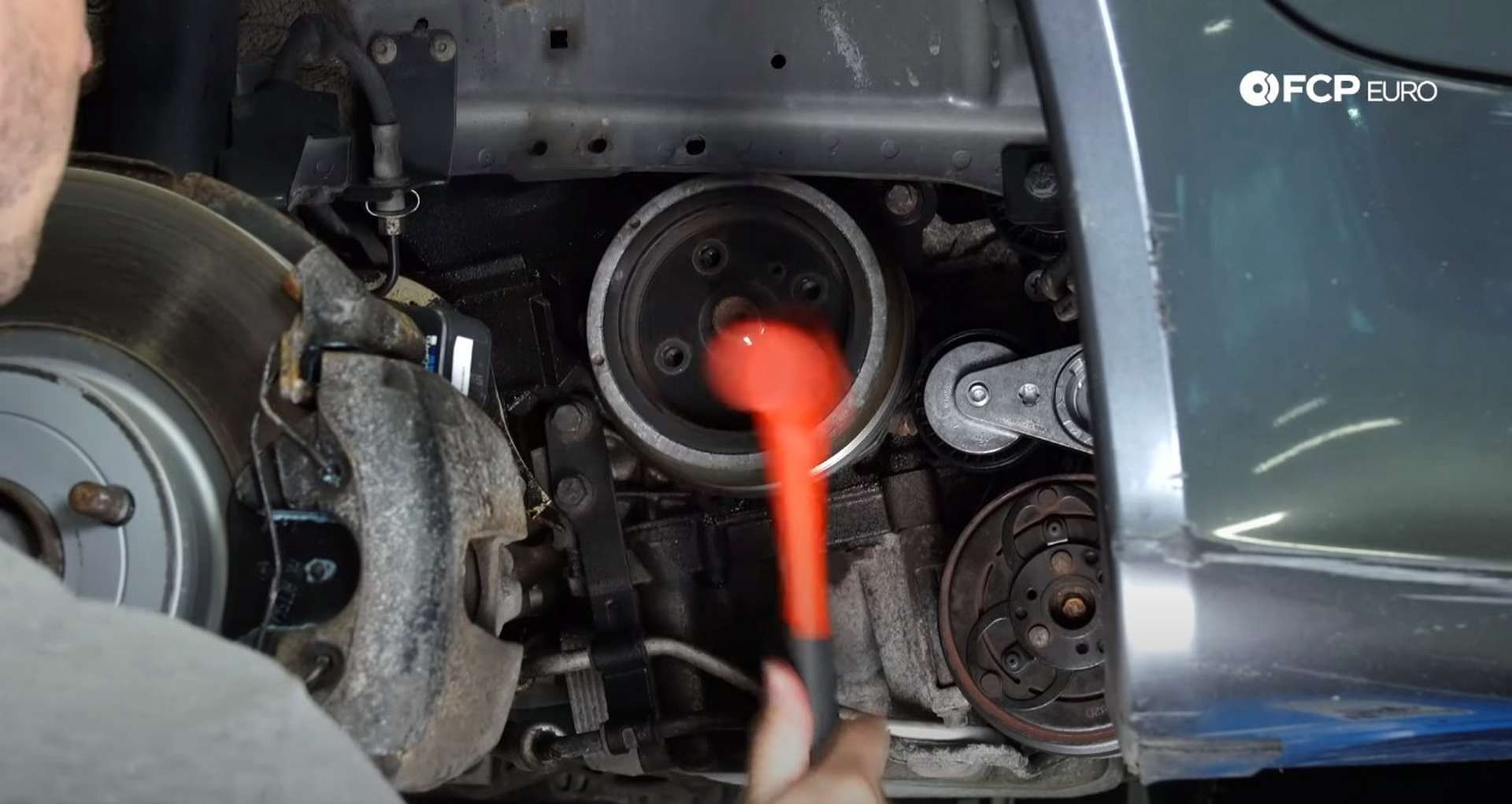 DIY Volvo P1 Timing Belt Replacement hitting the crank pulley with a mallet