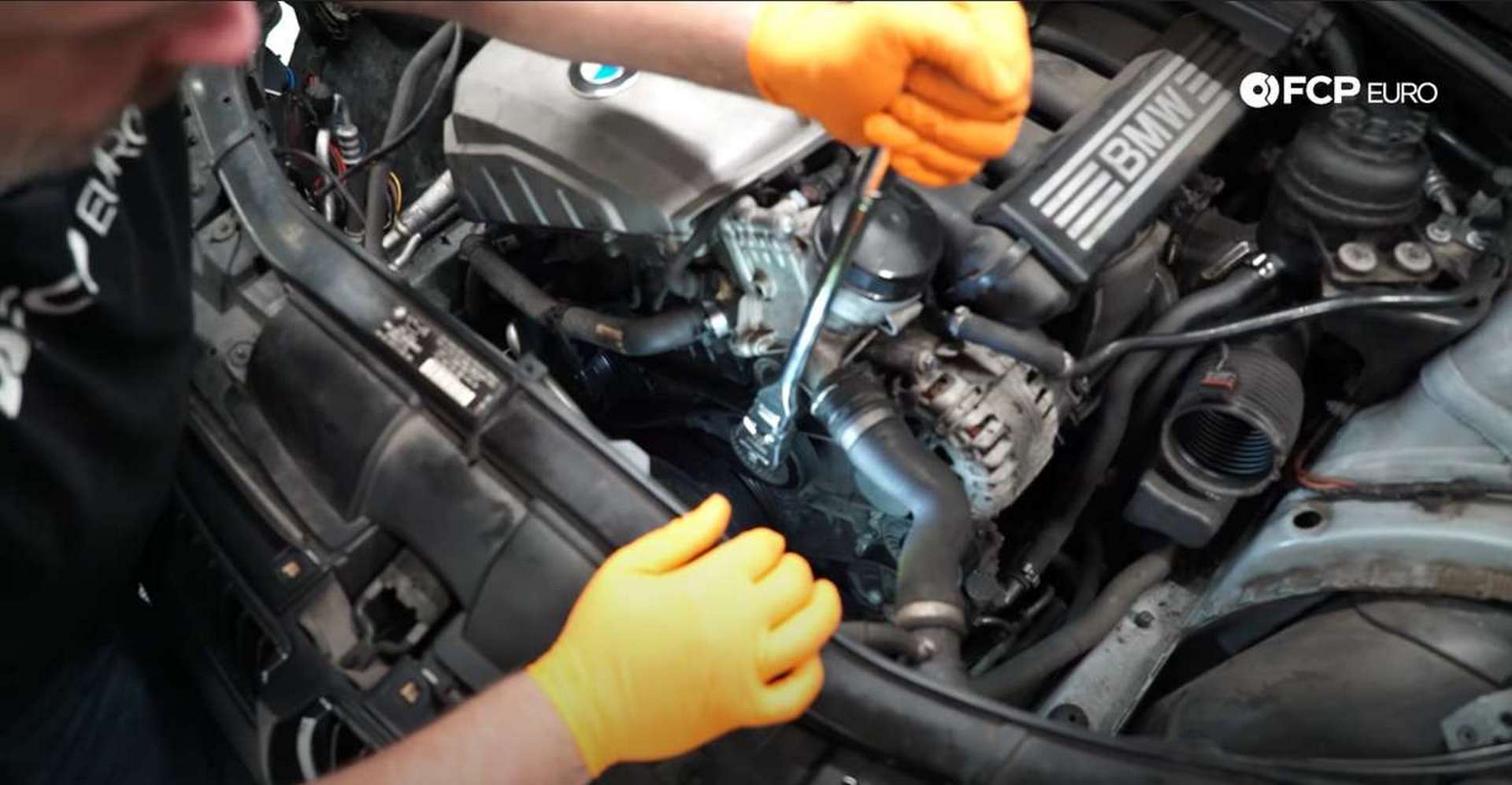 DIY BMW N52 Drive Belt Replacement releasing the tensioner's tension and removing the belt