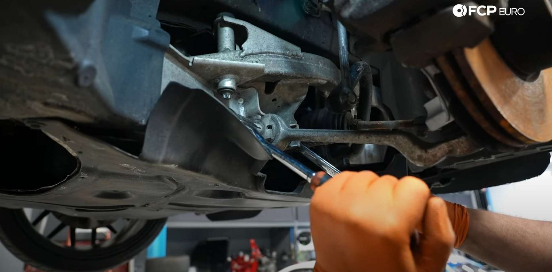 DIY BMW E9X Front Control Arm Upgrade removing the control arm’s inner mounting bolt