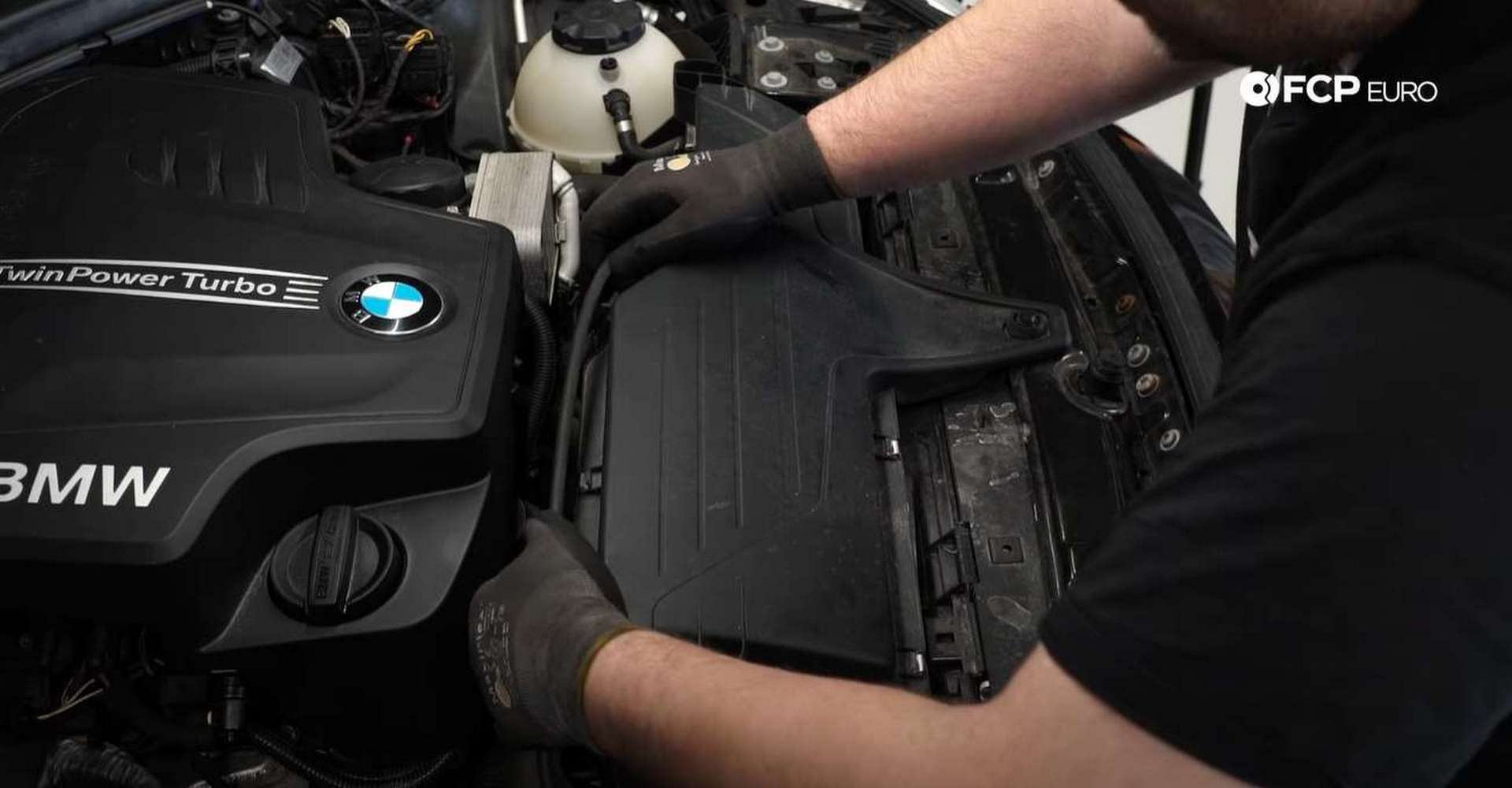 DIY BMW F30 Serpentine Belt Replacement pulling the hood cable off of the airbox