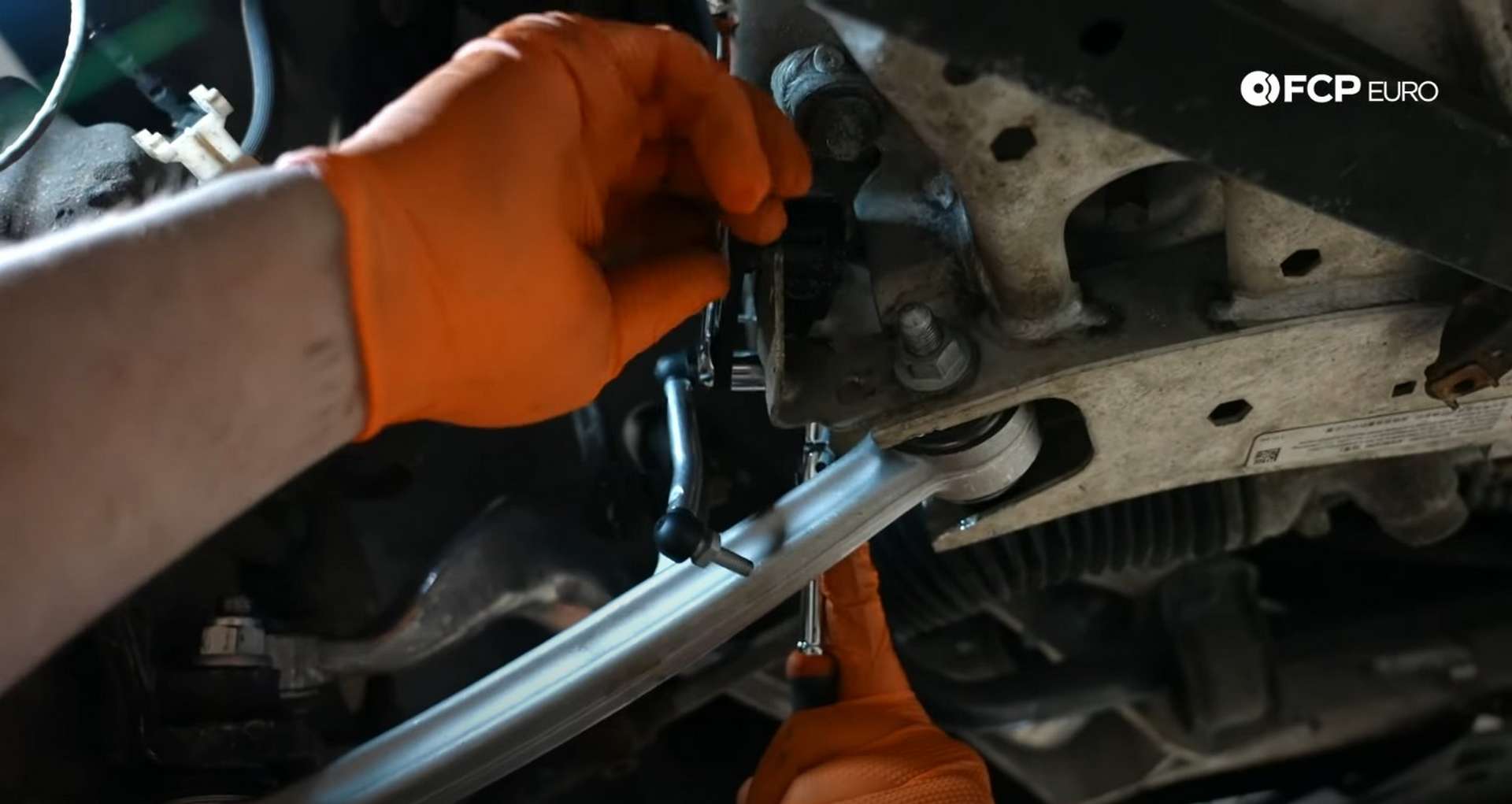 DIY BMW E9X Front Control Arm Upgrade tightening the headlight leveling arm