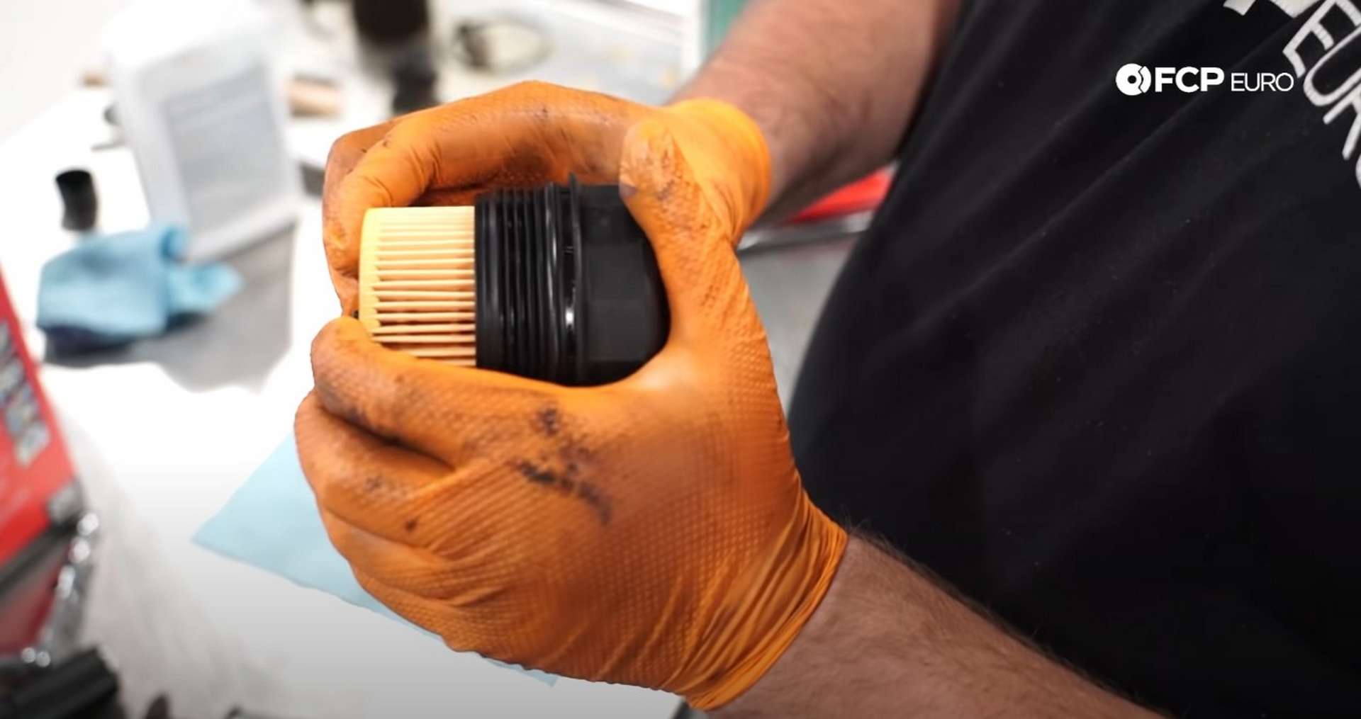 DIY BMW E9X Oil Filter Gasket Replacement installing a new filter into the cap