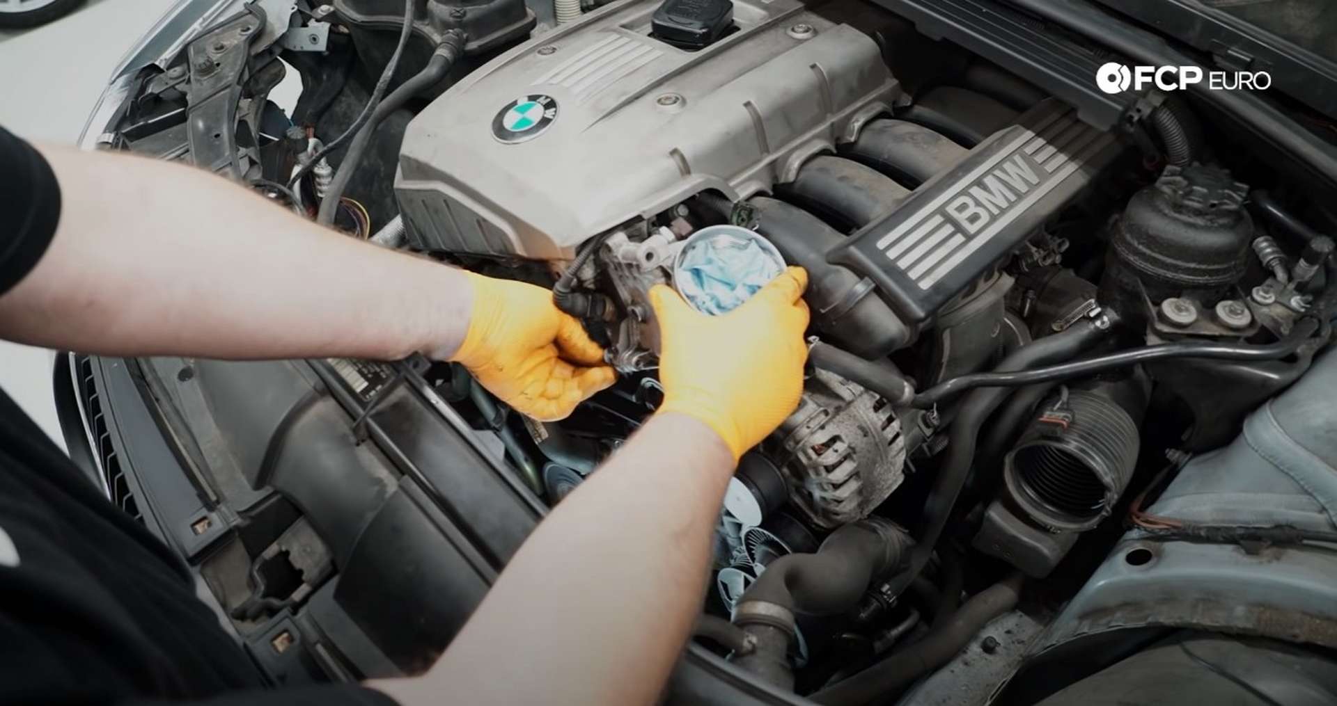 DIY BMW E9X Oil Filter Gasket Replacement threading in the housing's bolts
