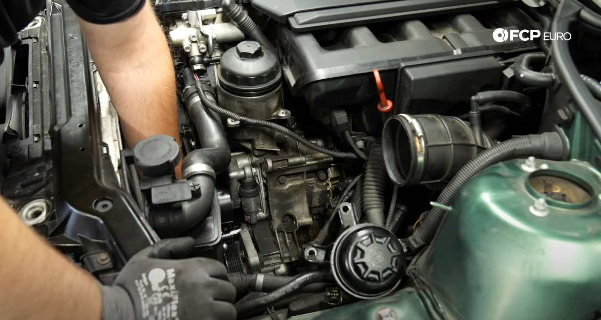 DIY BMW E46 Oil Filter Housing Gasket and VANOS Line Replacement removing the power steering bolts