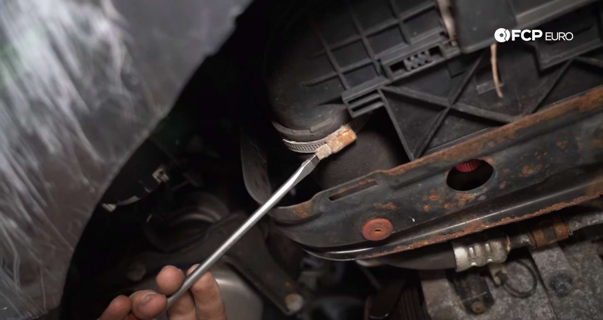 DIY Volvo Alternator and Serpentine Belt Replacement loosening the charge pipe to intercooler clamp