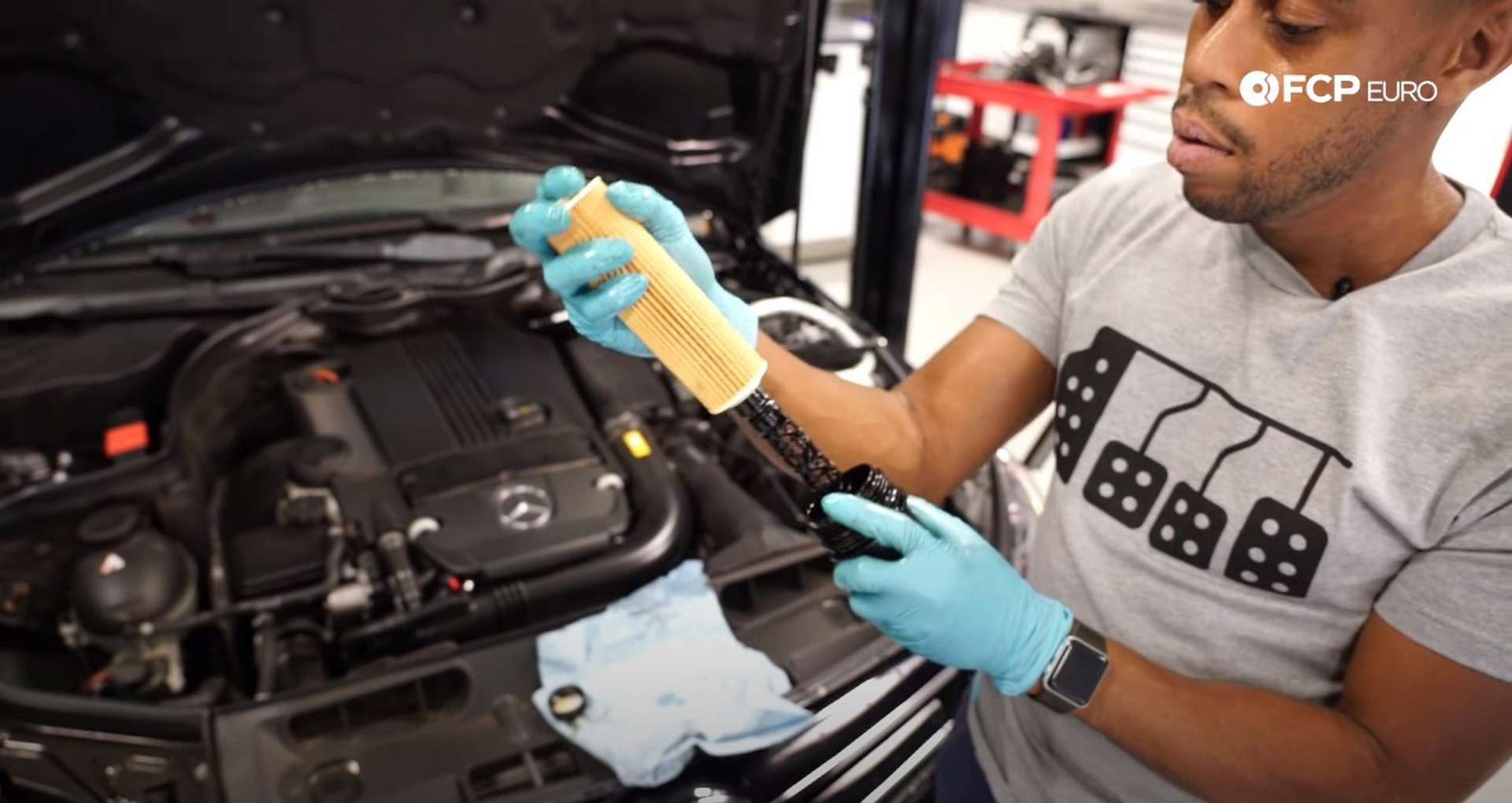 DIY Mercedes M271 Oil Change installing the new filter onto the cap