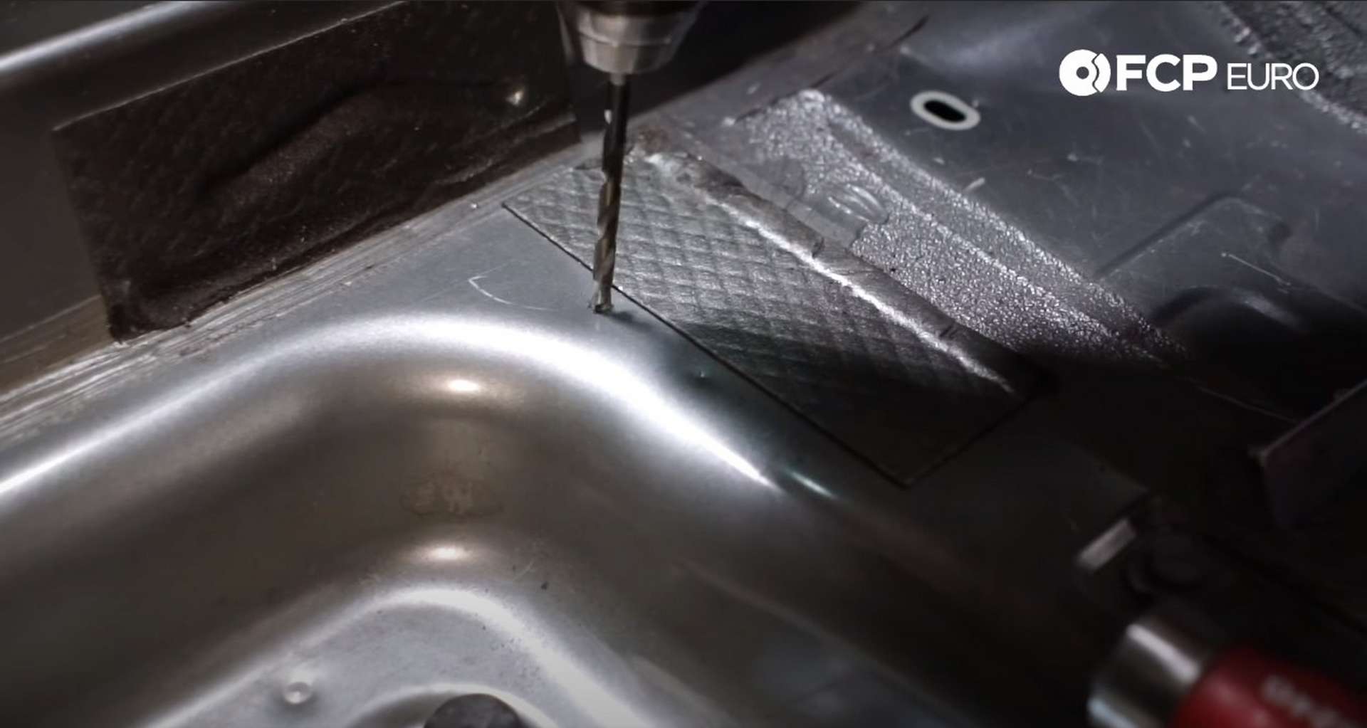 DIY Battery Relocation drilling the battery bracket's mounting plate holes