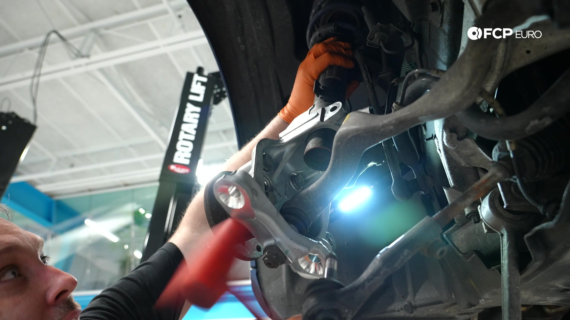 DIY BMW E90 Steering Knuckle Replacement tapping the knuckle up on the strut