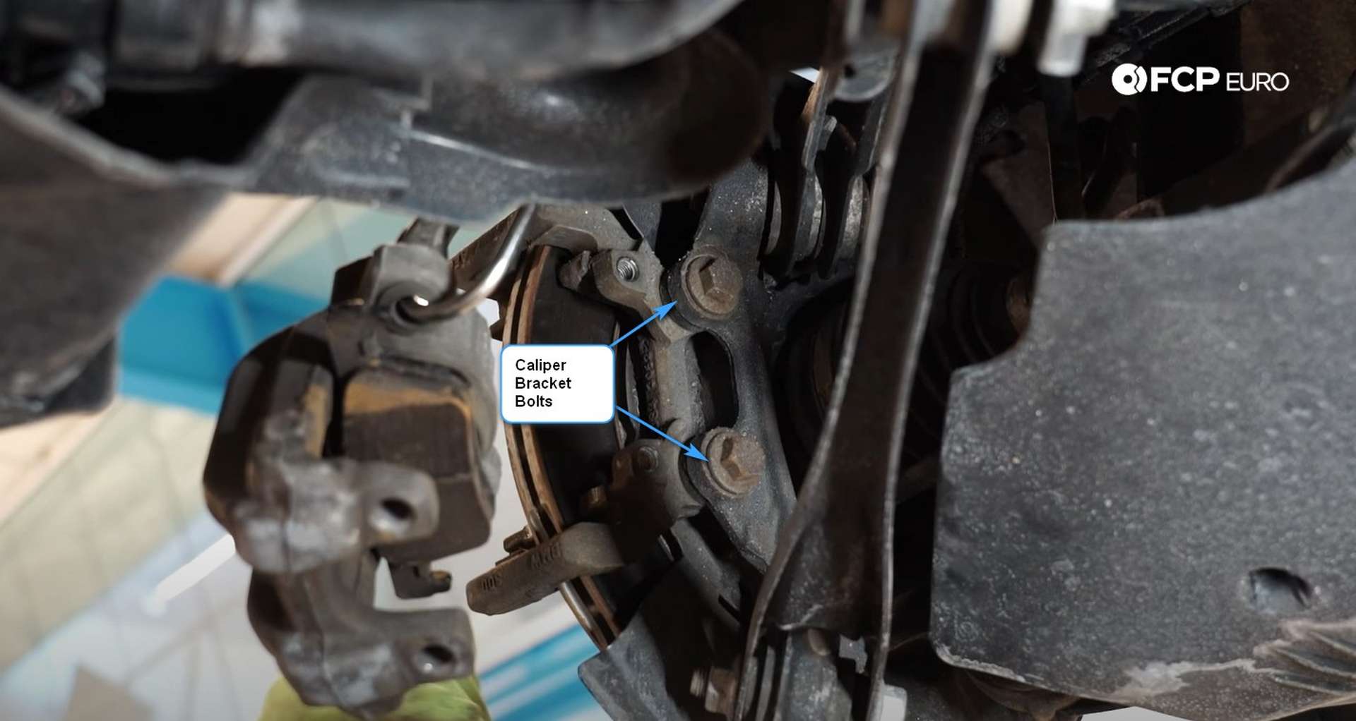 DIY BMW F30 Rear Brake Service removing the caliper bracket bolts