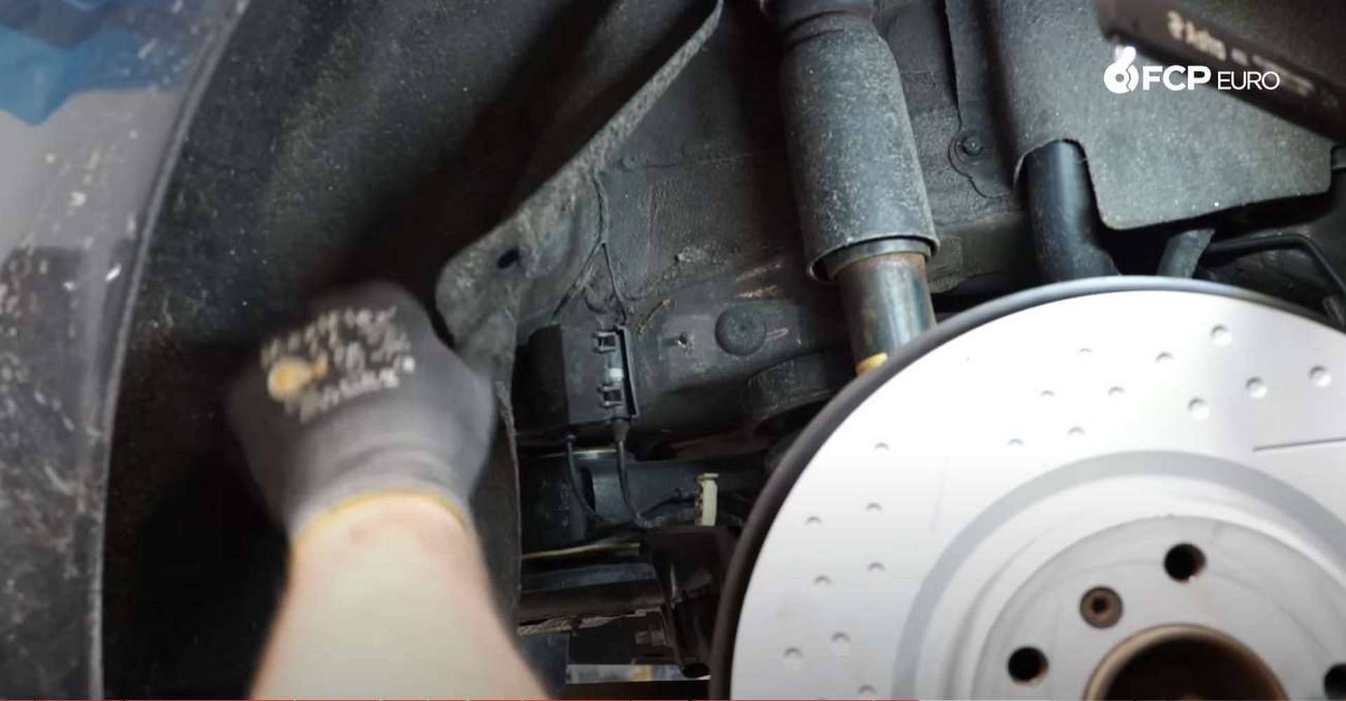 DIY BMW F30 M-Sport Rear Brake Service revealing the junction box