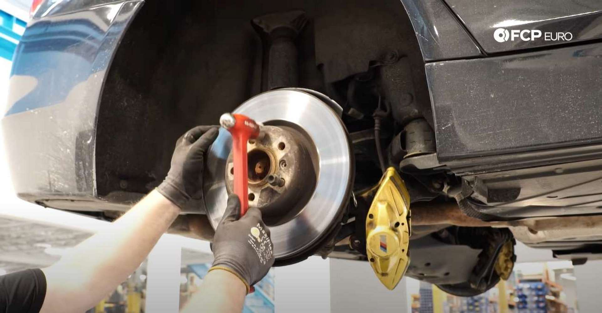DIY BMW F30 M-Sport Rear Brake Service hitting the rotor hat to break the corrosion